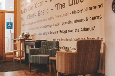a waiting room with two chairs and a sign on the wall at Oban Youth Hostel in Oban