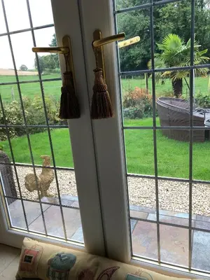 a dog sitting on a porch looking out of a window at Retreat at The Knowe Auchincruive Estate in Ayr