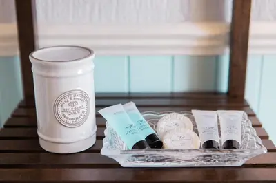 a container of chocolates and a cup on a table at Drumfearne Guesthouse & Tearoom in Carradale