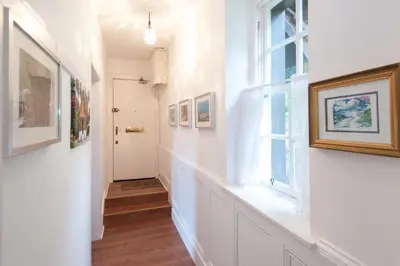 a hallway with white walls and a window at Dean Village Cottage in Edinburgh