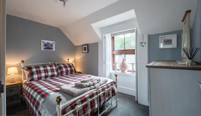 a bedroom with a bed and a window at Socair in Callander