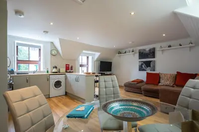 a kitchen and a living room with a table and chairs at Socair in Callander