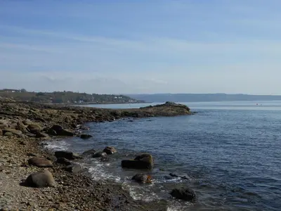 a group of rocks on the shore of a body of water at Knockderry Country House Hotel in Cove