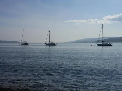 three boats floating in a large body of water at Knockderry Country House Hotel in Cove