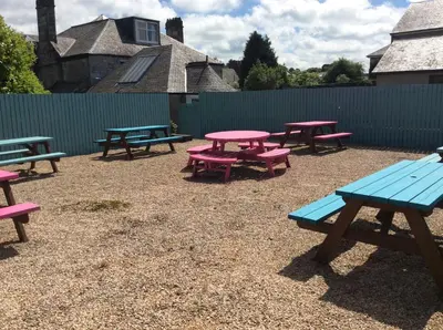 a group of picnic tables and a blue bench at Kirklands Hotel in Kinross