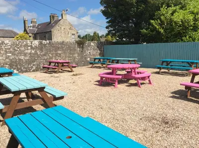 a group of picnic tables in a park at Kirklands Hotel in Kinross