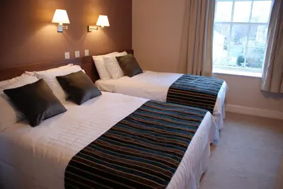 a hotel room with two beds in a room at Kirklands Hotel in Kinross