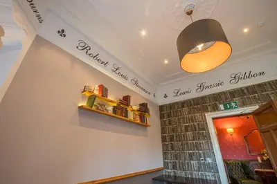 a shop with a light and a shelf on the wall at Sherbrooke Castle Hotel in Glasgow