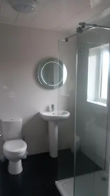 a bathroom with a toilet and a sink and a mirror at Ritchie selfcatering in Callander