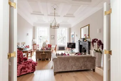 a living room filled with furniture and a fireplace at JOIVY Ultra Luxe Home near Princes Street in Edinburgh