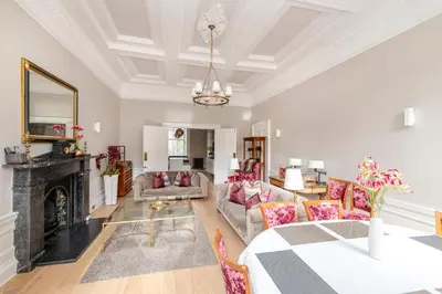 a living room with a couch and a fireplace at JOIVY Ultra Luxe Home near Princes Street in Edinburgh