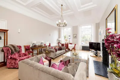 a living room with a couch and a tv at JOIVY Ultra Luxe Home near Princes Street in Edinburgh