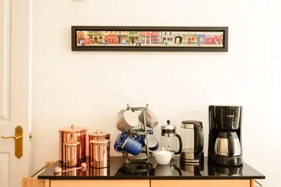 a kitchen with a counter with a coffee maker on it at JOIVY Gorgeous Flat near The Scotland Gallery in Edinburgh