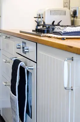 a kitchen counter with towels hanging on the oven doors at JOIVY Stylish Apt in Trendy New Town Location in Edinburgh