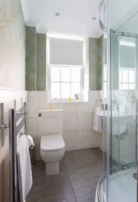 a bathroom with a toilet and a glass shower at JOIVY Charming Nest for Two with Castle View in Edinburgh
