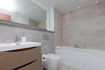 a bathroom with a toilet and a sink and a tub at Luxurious Central Edinburgh Apartment - Sleeps 6 in Edinburgh