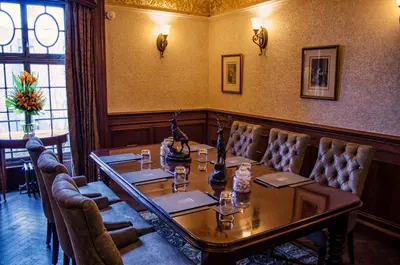 a dining room with a table and leather chairs at The Bonham in Edinburgh