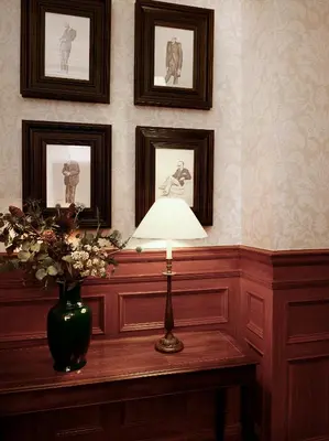 a table with a lamp and a vase with flowers at Hapimag Resort Edinburgh in Edinburgh