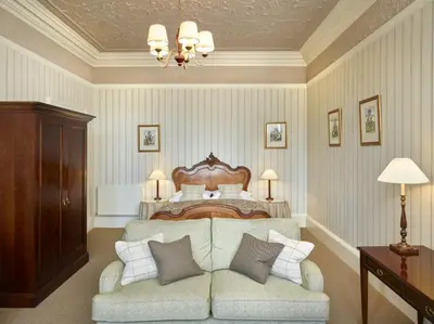 a bedroom with a bed and a couch with pillows at Hapimag Resort Edinburgh in Edinburgh