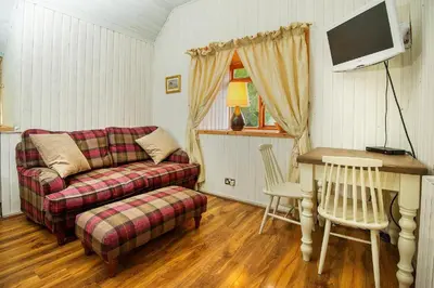 a living room with a couch and a table at The Falls Of Dochart Inn in Killin