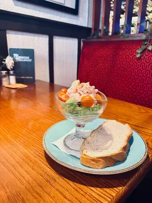 a bowl of salad and a sandwich on a table at The Ayrshire and Galloway in Ayr
