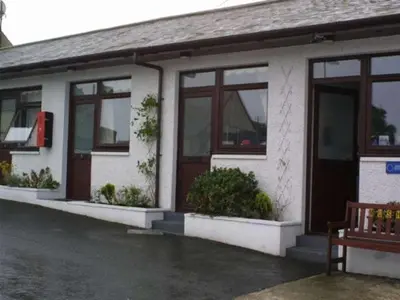 a house with windows and a bench in front of it at The Thistle in Stranraer