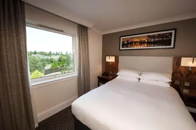 a hotel room with a bed and a large window at Doubletree By Hilton Glasgow Strathclyde in Bellshill
