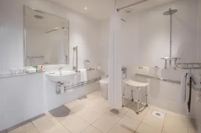 a white bathroom with a sink and a toilet at Glasgow Grosvenor Hotel in Glasgow