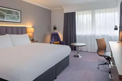 a hotel room with a bed and a desk and chair at DoubleTree by Hilton Edinburgh Airport in Ingliston