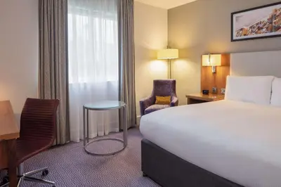 a hotel room with a bed and a desk and chair at DoubleTree by Hilton Edinburgh Airport in Ingliston