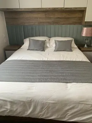 a large white bed with two pillows on it at Brookwood Sea View 14 in Dunoon