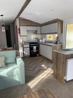a kitchen with a couch and a stove top oven at Brookwood Sea View 14 in Dunoon