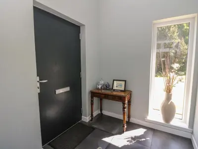 a black door in a room with a table and a window at Sobrachan in Braevallich