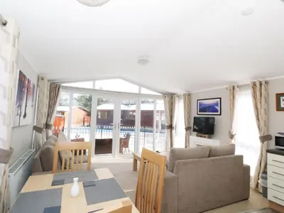 a living room with a couch and a table at 32 Cruachan Lodge in Auchterarder