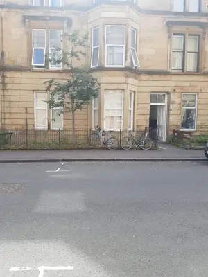 two bikes parked in front of a building at Bentinck Street Ground Floor Apartment in Glasgow