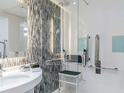 a bathroom with a sink and a mirror at Novotel Edinburgh Park in Edinburgh