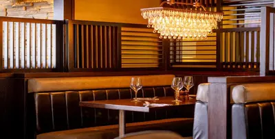 a dining room with two wine glasses on a table at The Torrance Hotel in East Kilbride