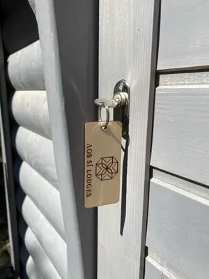 a lock on a door with a tag on it at Aos Sí Lodges in Ballachulish