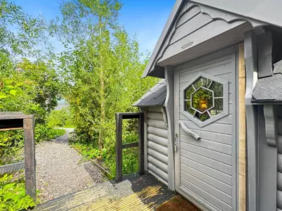 a garage with a window on the side of it at Aos Sí Lodges in Ballachulish