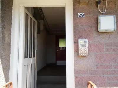 an entrance to a building with a door and a sign at Homestay, Number 29, Dunollie in Oban