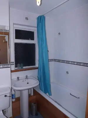 a bathroom with a sink and a tub and a toilet at Homestay, Number 29, Dunollie in Oban