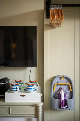 a room with a table with plates and a tv at No. 53 Frederick Street in Edinburgh