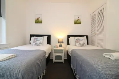 two beds sitting next to each other in a bedroom at Signature - Glen Lee House in Glasgow