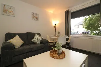 a living room with a couch and a table at Signature - Glen Lee House in Glasgow