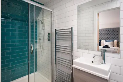 a bathroom with a sink and a glass shower at Mill House Monzie in Crieff