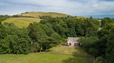 an aerial view of a house in the middle of a field at Mill House Monzie in Crieff