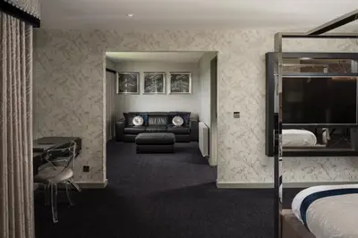 a hotel room with a bed and a couch at Radstone Hotel in Larkhall