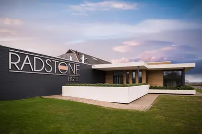 a house with a sign on the side of it at Radstone Hotel in Larkhall
