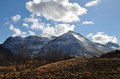 a snow covered mountain with clouds in the sky at The Corran in Onich