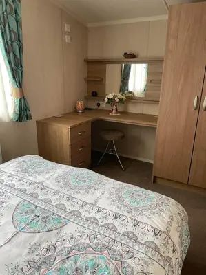 a small bedroom with a bed and a desk at Swift bordeaux 24 in Dunoon